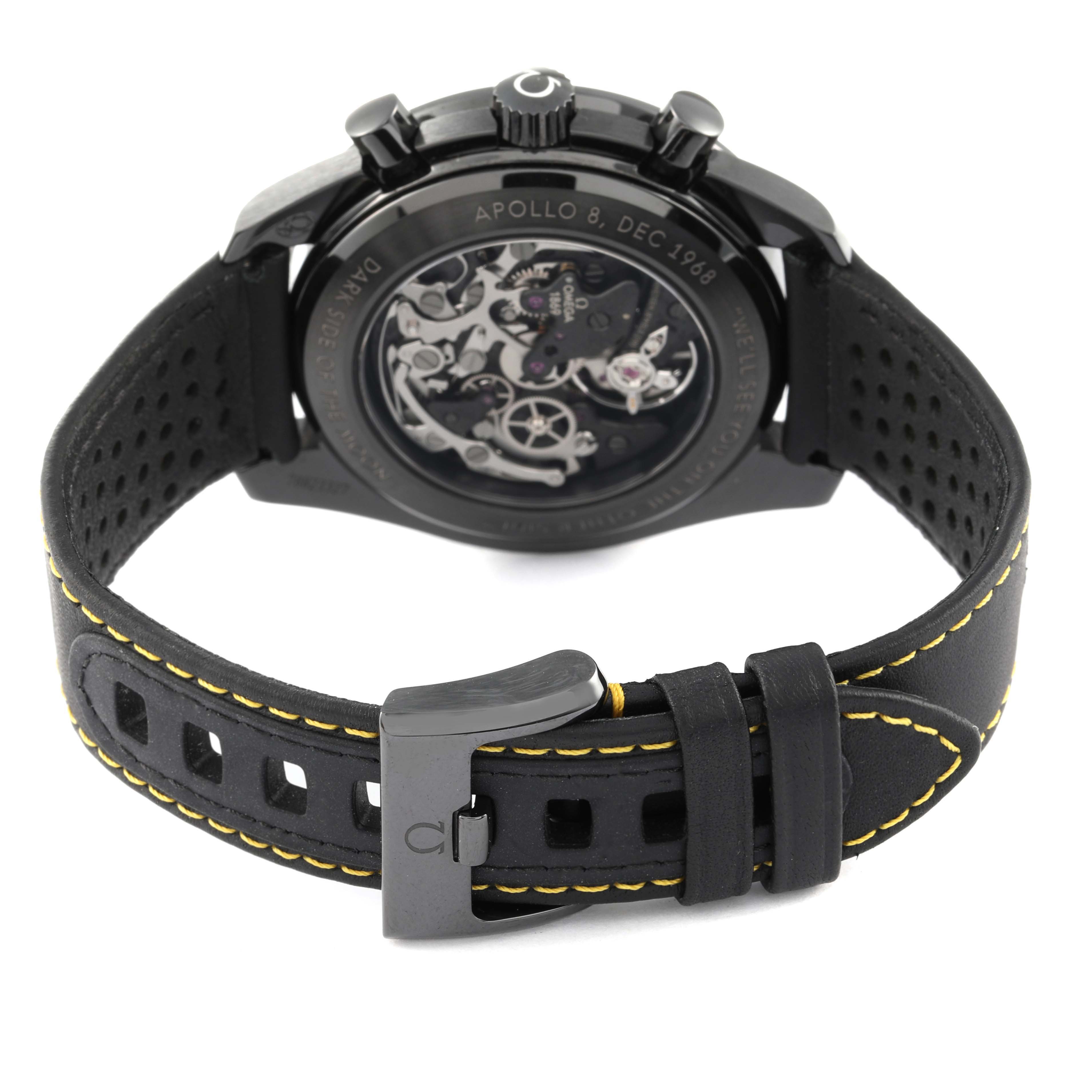 The image shows the back of an Omega Speedmaster 311.92.44.30.01.001 Men
s Ceramic Black Dial 311.92.44.30.01.001 Men
s Ceramic Black Dial watch, highlighting the open case back and leather strap with yellow stitching.