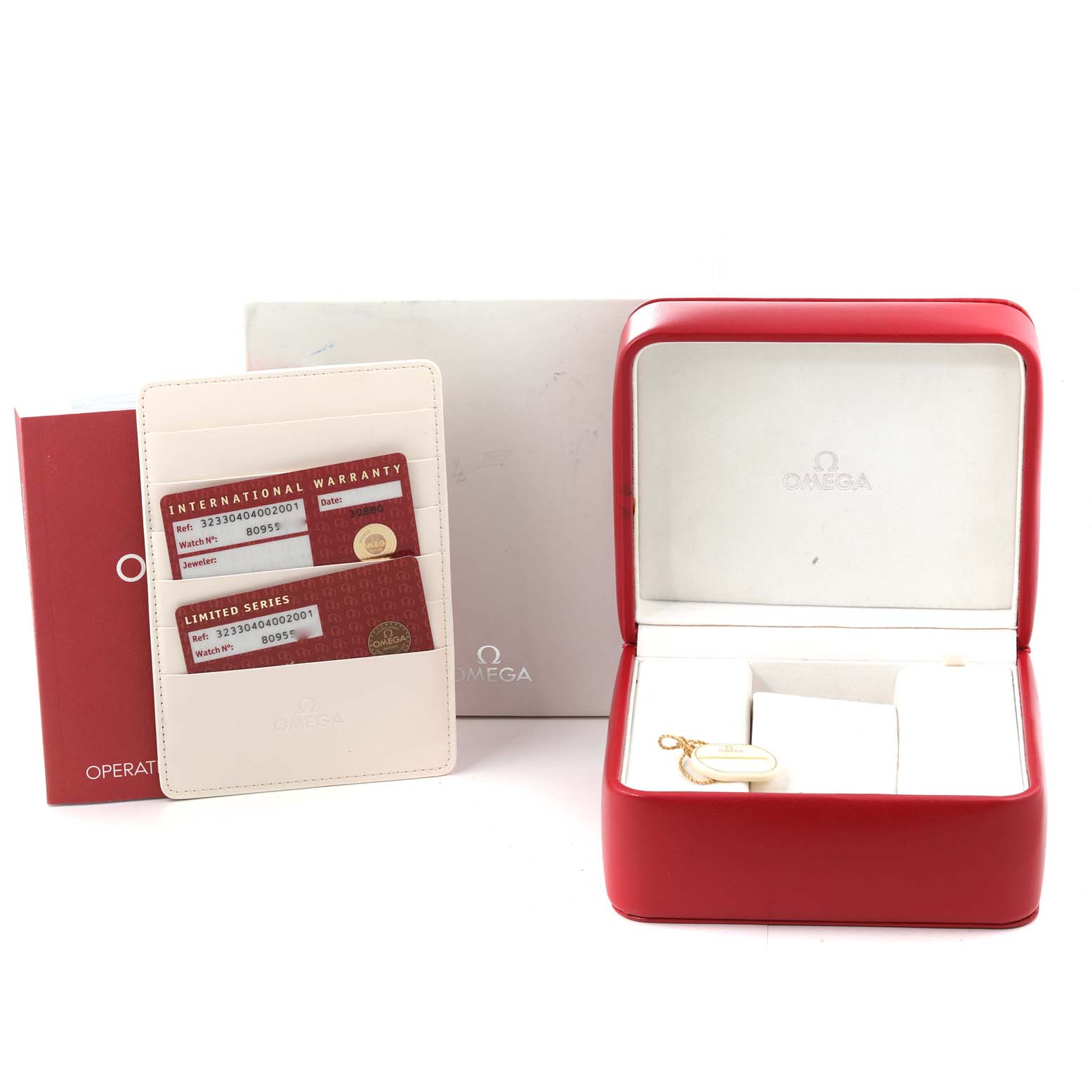 The image shows an Omega Speedmaster 323.30.40.40.02.001 Men's Stainless Steel White Dial 323.30.40.40.02.001 Men's Stainless Steel White Dial watch box, warranty cards, and an operating manual from a front-facing angle.