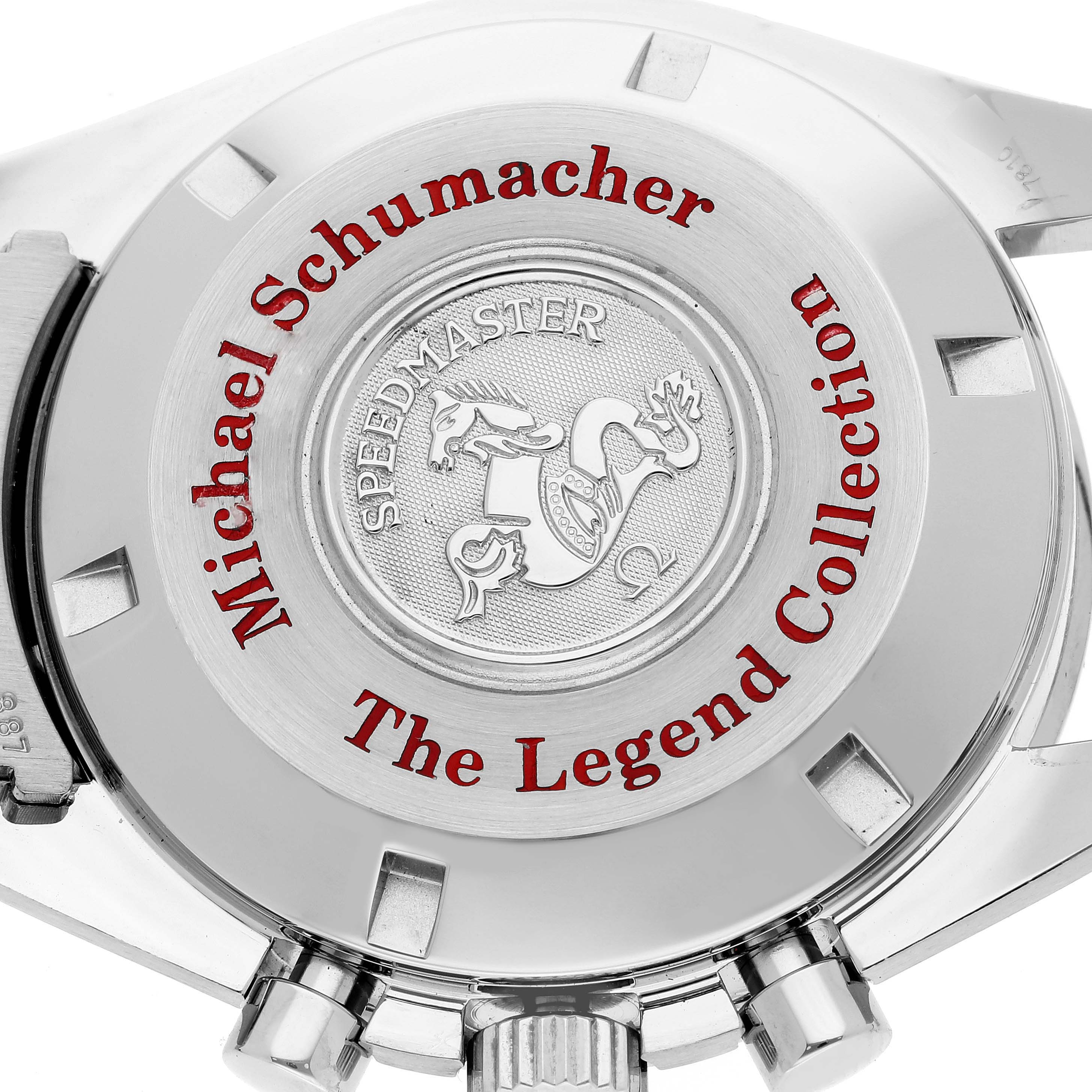 The image shows the back case of the Omega Speedmaster 3506.61.00 Men
s Stainless Steel Red Dial 3506.61.00 Men
s Stainless Steel Red Dial Michael Schumacher Legend Collection watch, featuring engraved text and a logo.