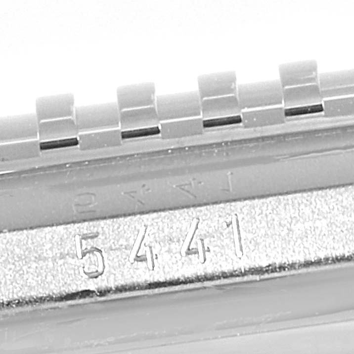 The image shows the side view of a Rolex Cellini 5441/9 Men
s White Gold Silver Dial 5441/9 Men
s White Gold Silver Dial model watch, focusing on the serial number and part of the bracelet.