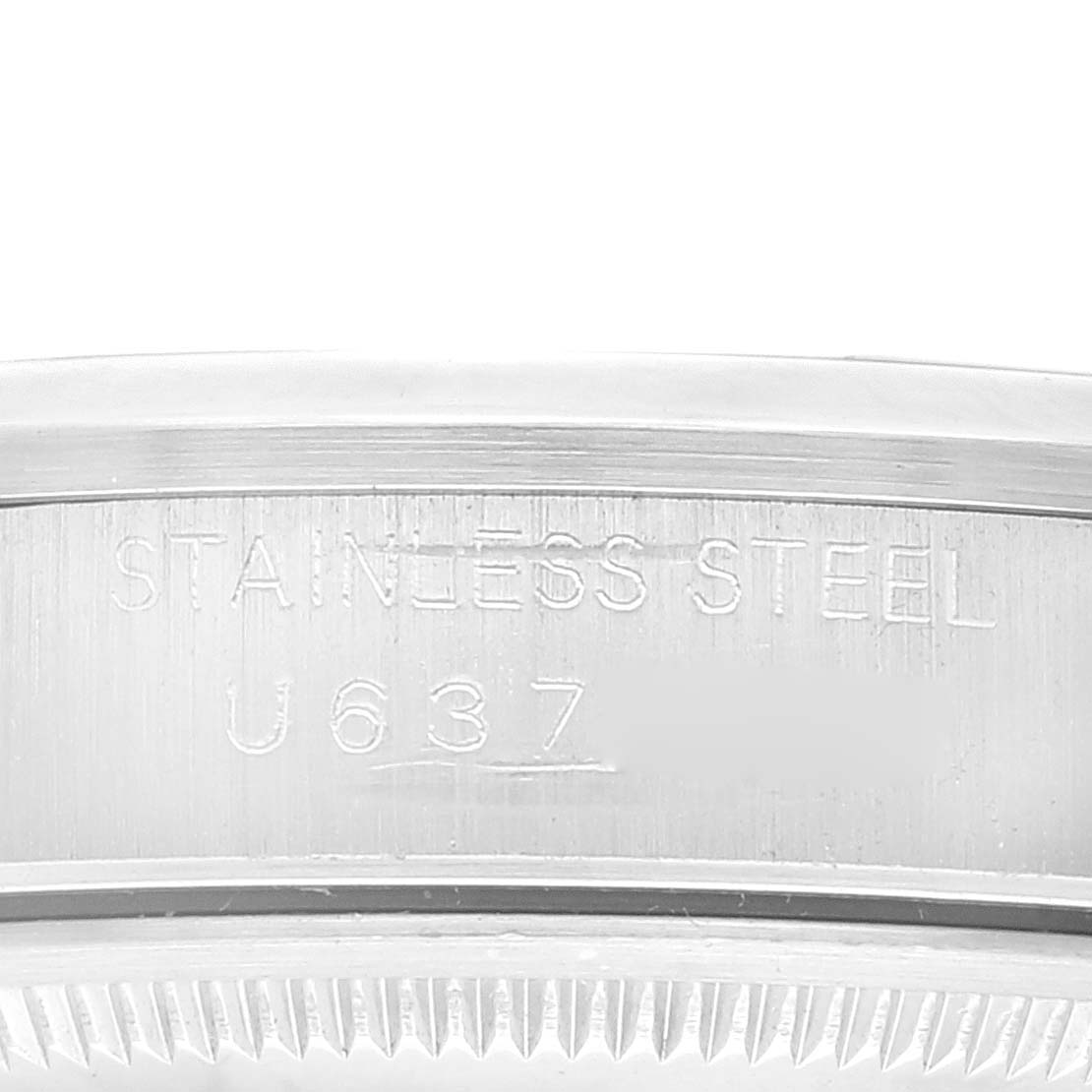 This image shows a close-up of the case back engraving on a Rolex Date 15200 Men's Stainless Steel Blue Dial 15200 Men's Stainless Steel Blue Dial model, focusing on the "Stainless Steel" and serial number.