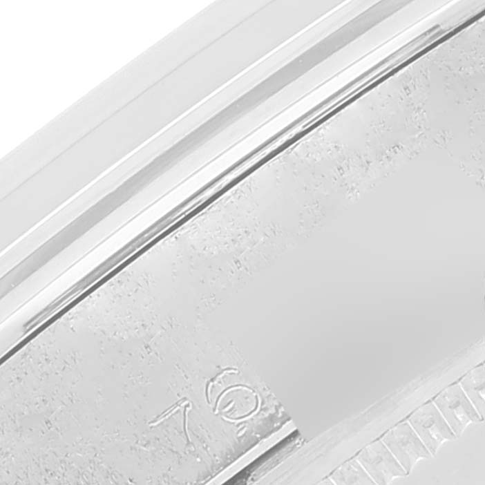 The image shows a close-up of the edge and part of the bezel with partial engravings on the Vintage Collection Rolex watch.