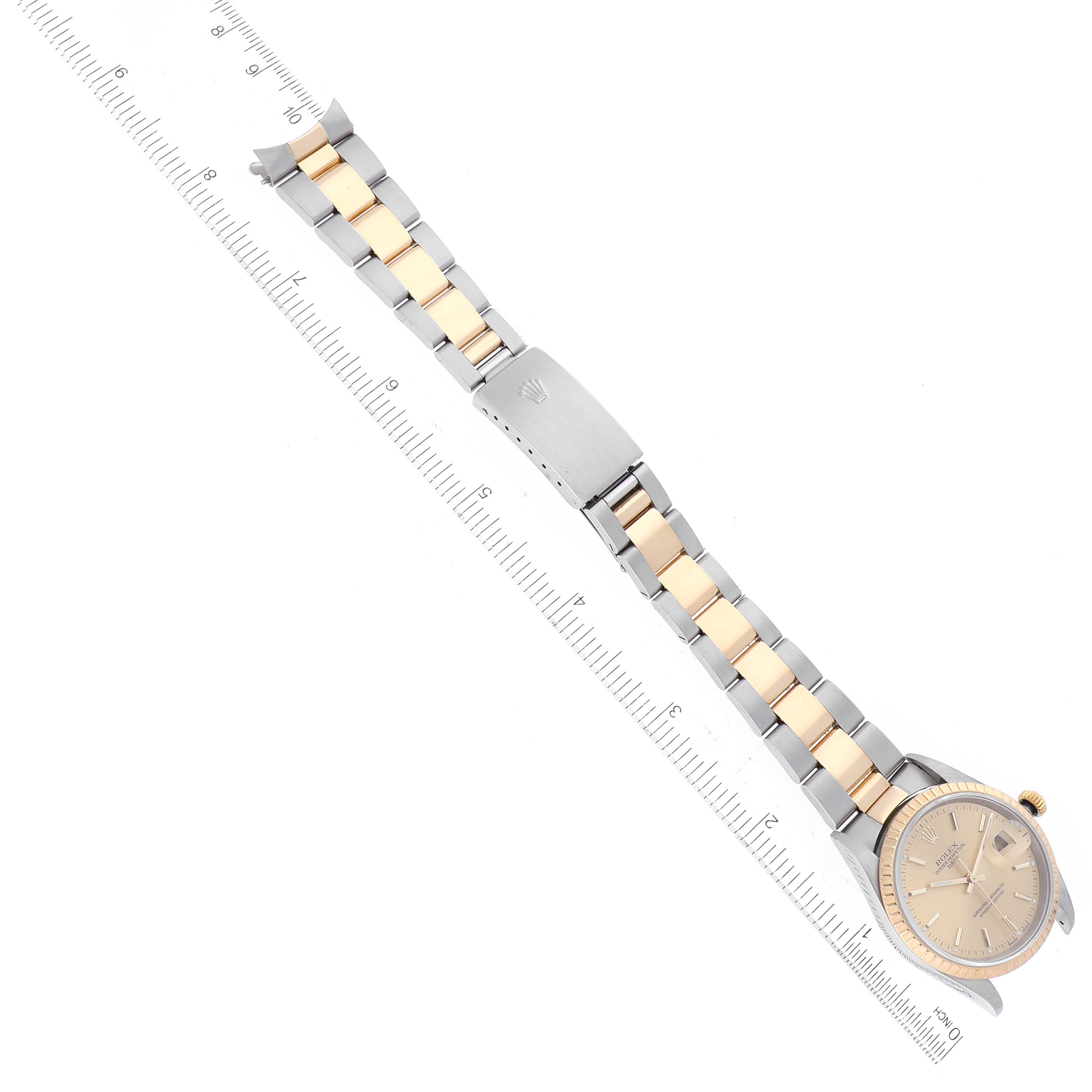 The image shows a Rolex Date 15223 Men's Steel and Gold (two tone) Champagne Dial 15223 Men's Steel and Gold (two tone) Champagne Dial model watch at an angle, highlighting its two-tone bracelet and clasp.