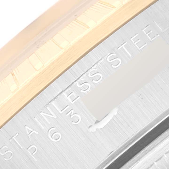 This close-up shows the stainless steel and gold bezel of a Rolex Date 15223 Men's Steel and Gold (two tone) Champagne Dial 15223 Men's Steel and Gold (two tone) Champagne Dial model watch.