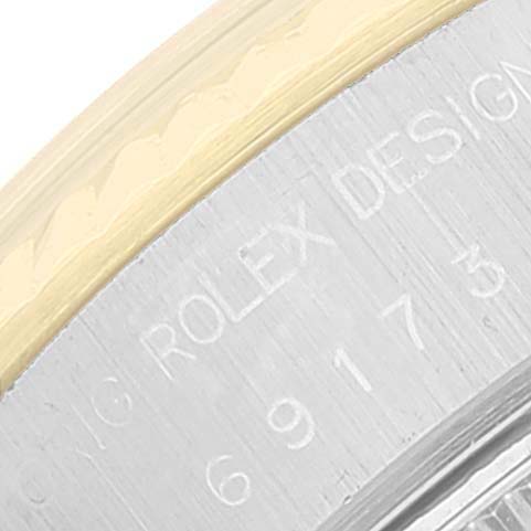 This close-up image shows the engravings on the side of the case of a Rolex Date 69173 Women's Steel and Gold (two tone) Silver Dial 69173 Women's Steel and Gold (two tone) Silver Dial model watch.