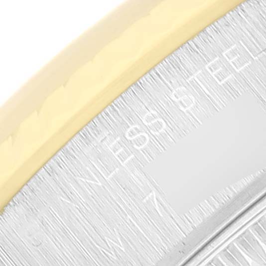 The image shows a close-up of part of the bezel and case back of a Rolex Datejust 69173 Women's Steel and Gold (two tone) Champagne Dial 69173 Women's Steel and Gold (two tone) Champagne Dial watch, highlighting the "STAINLESS STEEL" engraving.