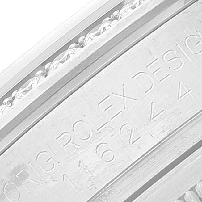 The image shows a close-up of the Rolex Datejust 116244 Men's Stainless Steel Black Dial 116244 Men's Stainless Steel Black Dial model's inner bezel with engraved text and part of the watch's serial number.