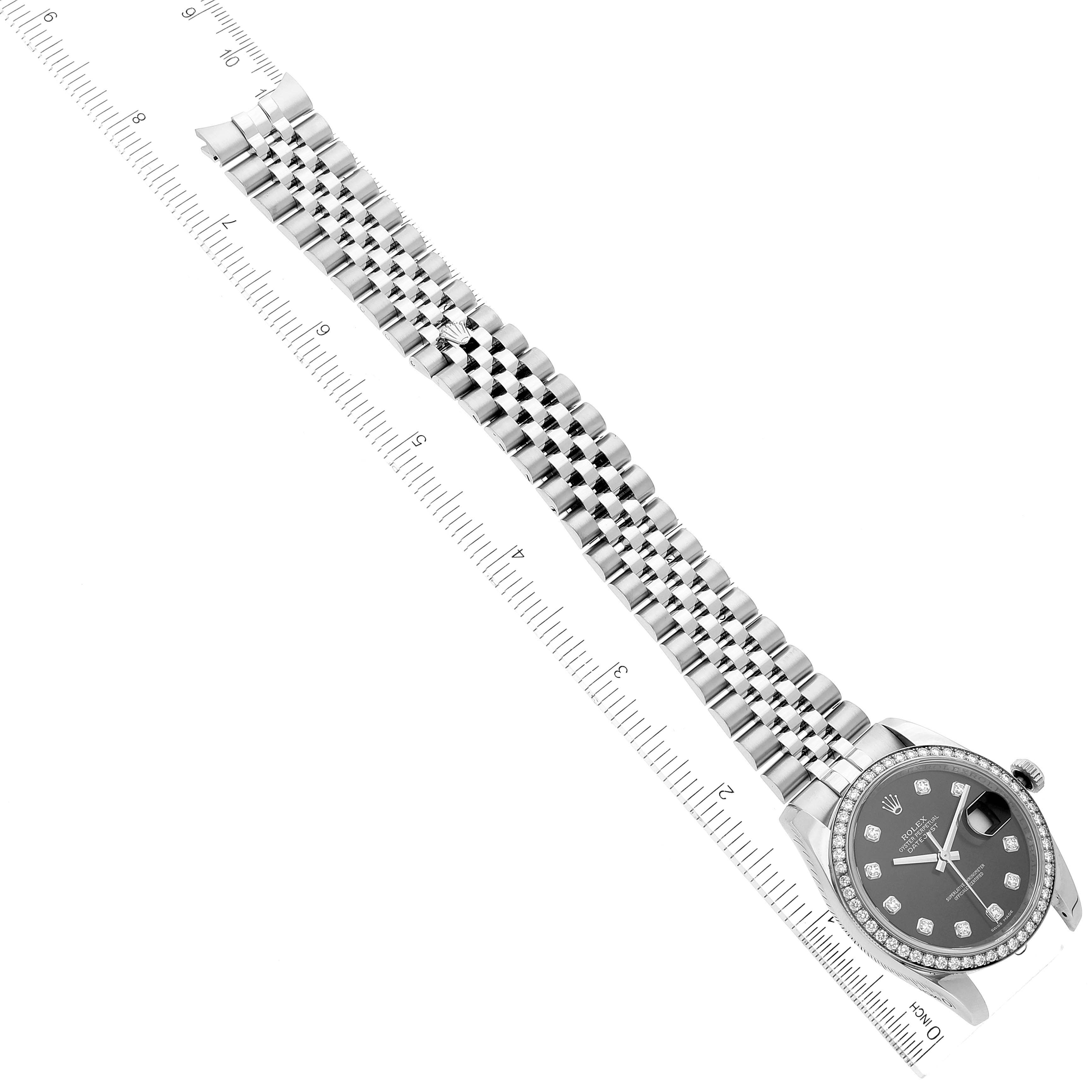 The image shows a Rolex Datejust 116244 Men's Stainless Steel Black Dial 116244 Men's Stainless Steel Black Dial watch at a diagonal angle, featuring its face, bracelet, and part of a ruler for scale.