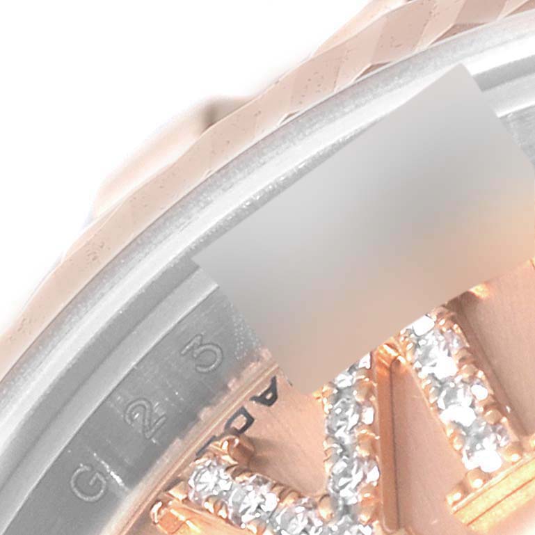 The image shows a close-up of the bezel, part of the dial, and diamond markers on the Rolex Datejust 179171 Women
s Steel and Gold (two tone) Pink Dial 179171 Women
s Steel and Gold (two tone) Pink Dial model.