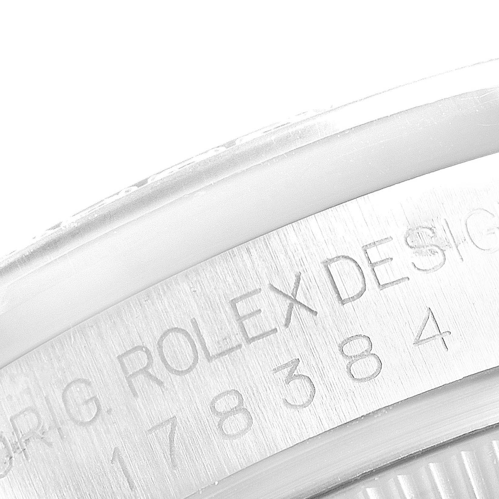 This image shows a close-up of the engraving on the case back rim of a Mid-Size Rolex watch.