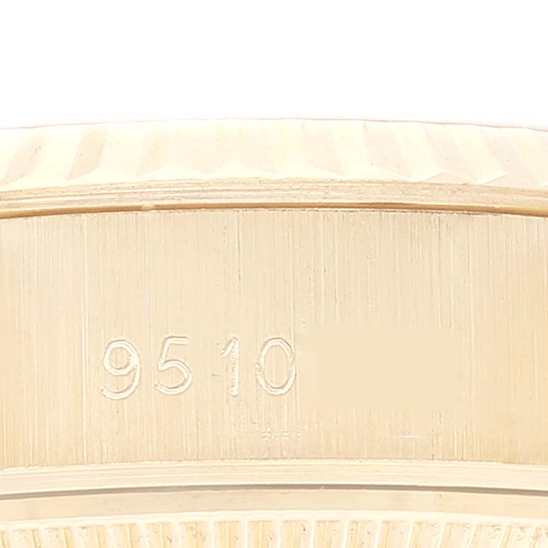 This image shows a close-up of the case side of a Rolex President 69178 Women's Yellow Gold Champagne Dial 69178 Women's Yellow Gold Champagne Dial model, highlighting its engraved serial number.