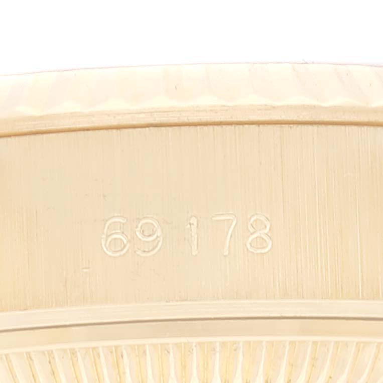 This image shows a close-up of the side profile of a Rolex President 69178 Women's Yellow Gold Champagne Dial 69178 Women's Yellow Gold Champagne Dial model watch with the number 69178 engraved on it.