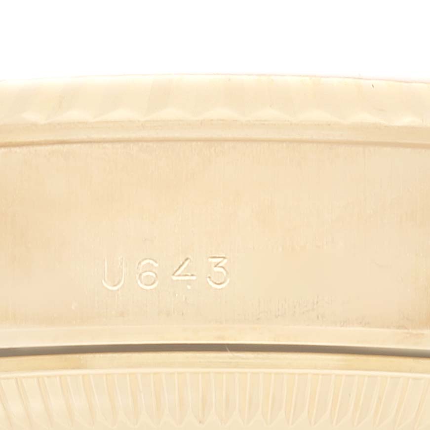 The image shows a close-up of the Rolex President 69178 Women's Yellow Gold Champagne Dial 69178 Women's Yellow Gold Champagne Dial model's bezel, highlighting the serial number "U 643".