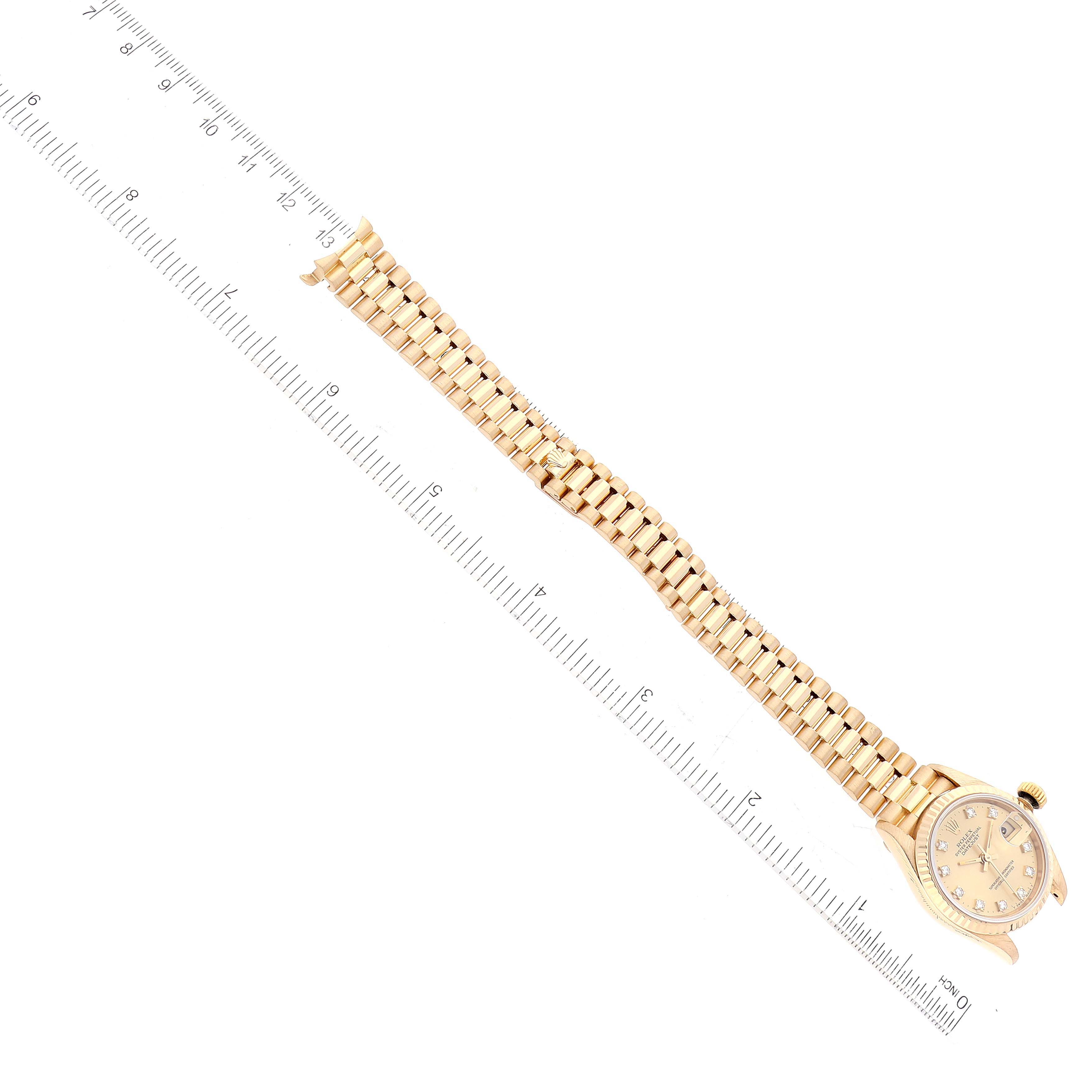 The image shows a Rolex President 69178 Women's Yellow Gold Champagne Dial 69178 Women's Yellow Gold Champagne Dial model watch laid flat with a ruler measuring its length.