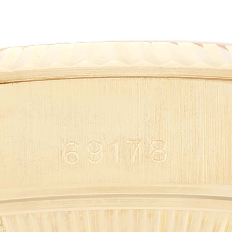 The image shows a close-up of the side of a Rolex President 69178 Women
s Yellow Gold Champagne Dial 69178 Women
s Yellow Gold Champagne Dial model watch, highlighting its serial number 69178.