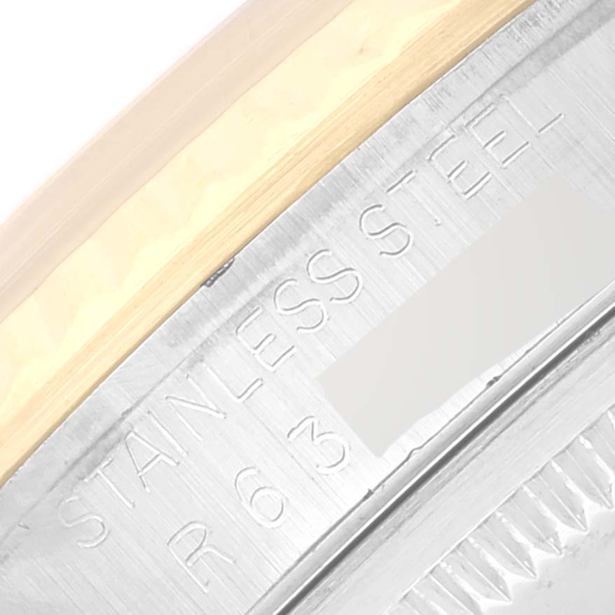 The image shows a close-up of the case back and the stainless steel engraving of a Rolex Datejust 16233 Men's Steel and Gold (two tone) Silver Dial 16233 Men's Steel and Gold (two tone) Silver Dial watch.