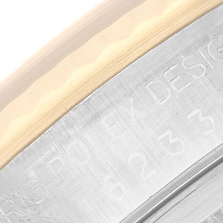 This close-up image shows a portion of the bezel and the engraved side of the case of a Rolex Datejust 16233 Men's Steel and Gold (two tone) Silver Dial 16233 Men's Steel and Gold (two tone) Silver Dial watch.