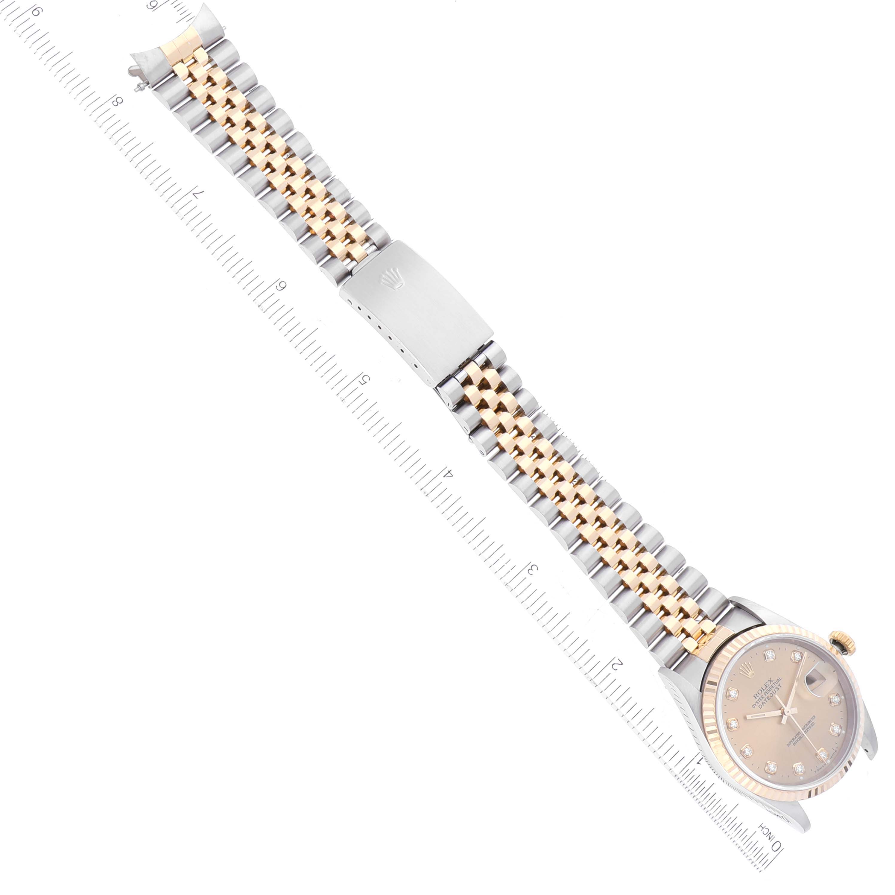 This image shows a Rolex Datejust 16233 Men's Steel and Gold (two tone) Champagne Dial 16233 Men's Steel and Gold (two tone) Champagne Dial watch laid flat, displaying the full face, bracelet, and clasp, positioned beside a ruler.