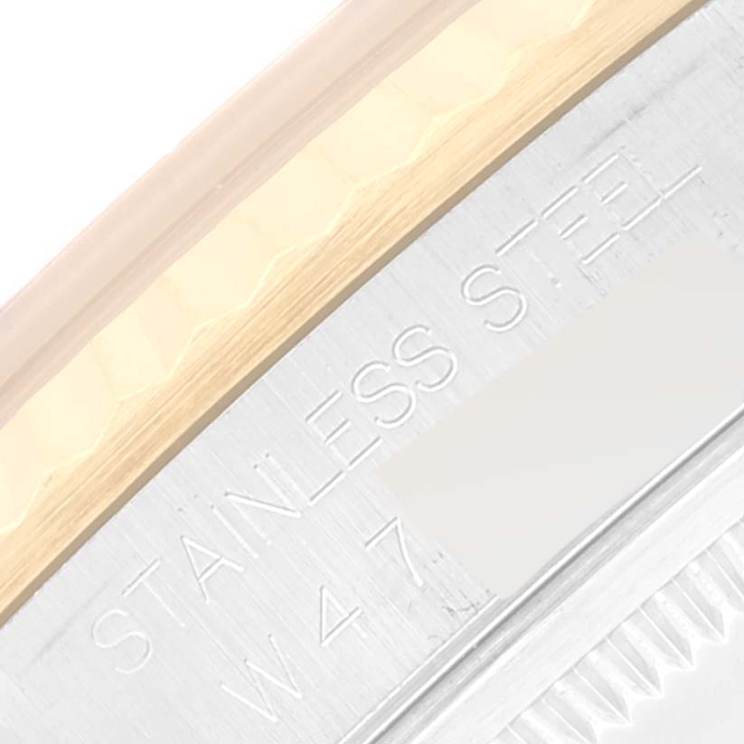 This image shows a close-up of the case side and part of the bezel of a Rolex Datejust 16233 Men's Steel and Gold (two tone) Champagne Dial 16233 Men's Steel and Gold (two tone) Champagne Dial, highlighting the "Stainless Steel" engraving.