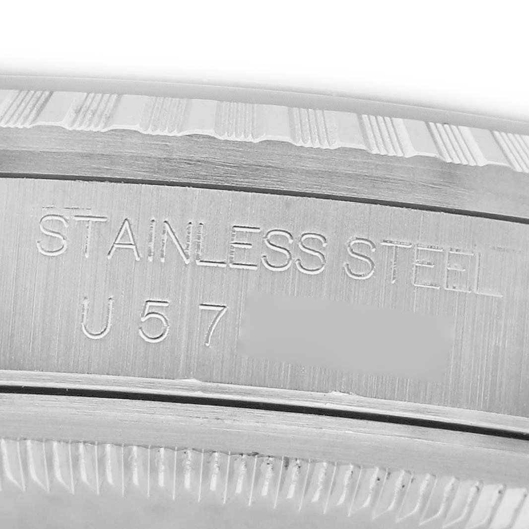 The image shows a close-up of the side and bezel of a Rolex Datejust 16220 Men's Stainless Steel Blue Dial, highlighting the "STAINLESS STEEL" engraving.