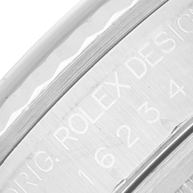 The image shows a close-up of the engraving on the case back rim of a Rolex Datejust 16234 Men's Stainless Steel Blue Dial 16234 Men's Stainless Steel Blue Dial watch.