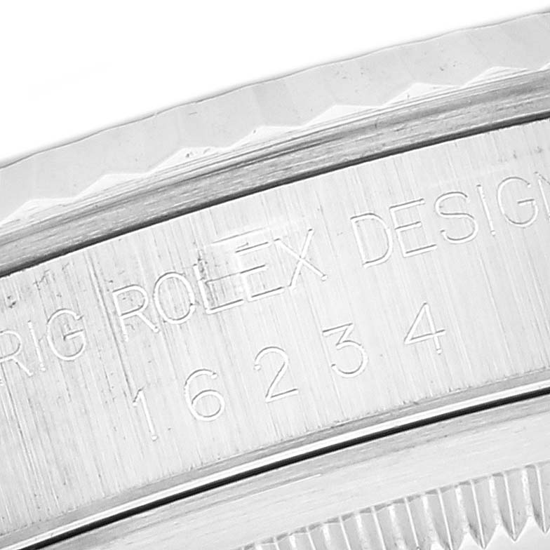The close-up image shows the engraved case side of a Rolex Datejust 16234 Men's Stainless Steel Blue Dial 16234 Men's Stainless Steel Blue Dial watch with the model number 16234.