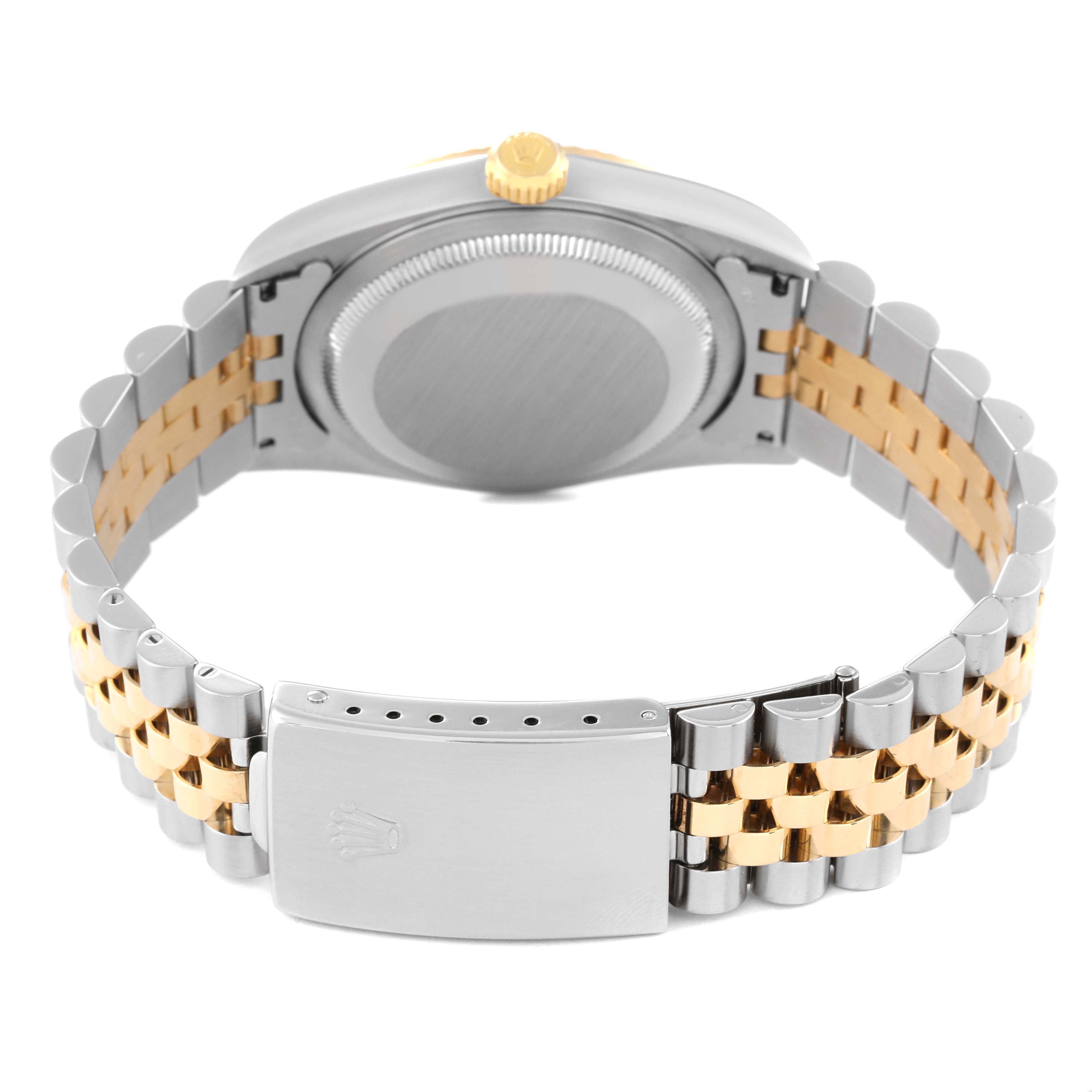 The image shows the back of a Rolex Datejust 16233 Men's Steel and Gold (two tone) Champagne Dial 16233 Men's Steel and Gold (two tone) Champagne Dial watch, highlighting its case, crown, and two-tone bracelet with the clasp open.