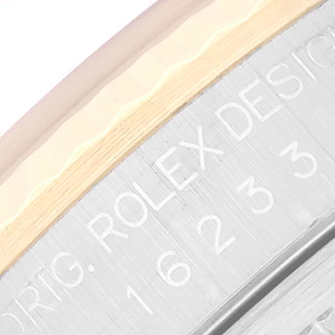 This close-up image shows the engraved details on the side of a Rolex Datejust 16233 Men's Steel and Gold (two tone) Champagne Dial 16233 Men's Steel and Gold (two tone) Champagne Dial model watch.