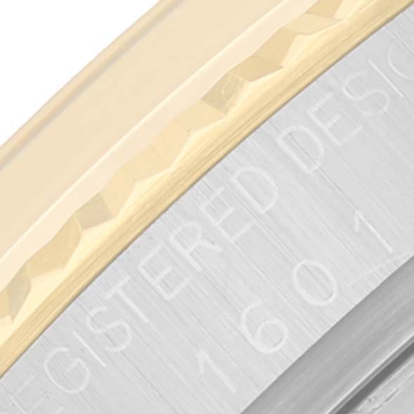 This close-up image shows the bezel and part of the case with "Registered Design" lettering of the Rolex Vintage Collection 1601 Men
s Steel and Gold (two tone) Champagne Dial 1601 Men
s Steel and Gold (two tone) Champagne Dial watch.