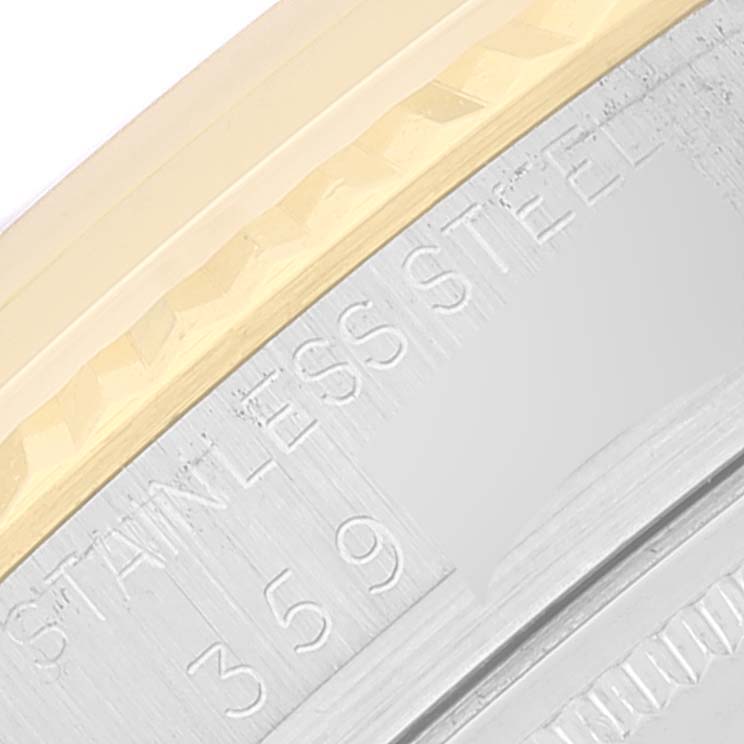 This close-up image shows a portion of the bezel and case back with engraving details of a Rolex Vintage Collection 1601 Men
s Steel and Gold (two tone) Champagne Dial 1601 Men
s Steel and Gold (two tone) Champagne Dial watch.