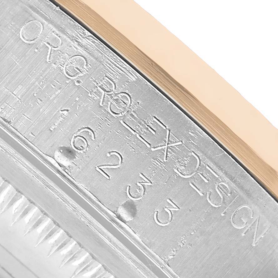 This close-up image shows the engraved side view of a Rolex Datejust 16233 Men's Stainless Steel Black Dial model, featuring part of the bezel and case.