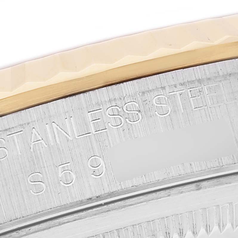 The image shows a close-up of the Rolex Datejust 16233 Men's Steel and Gold (two tone) Champagne Dial 16233 Men's Steel and Gold (two tone) Champagne Dial watch's stainless steel case and fluted bezel.