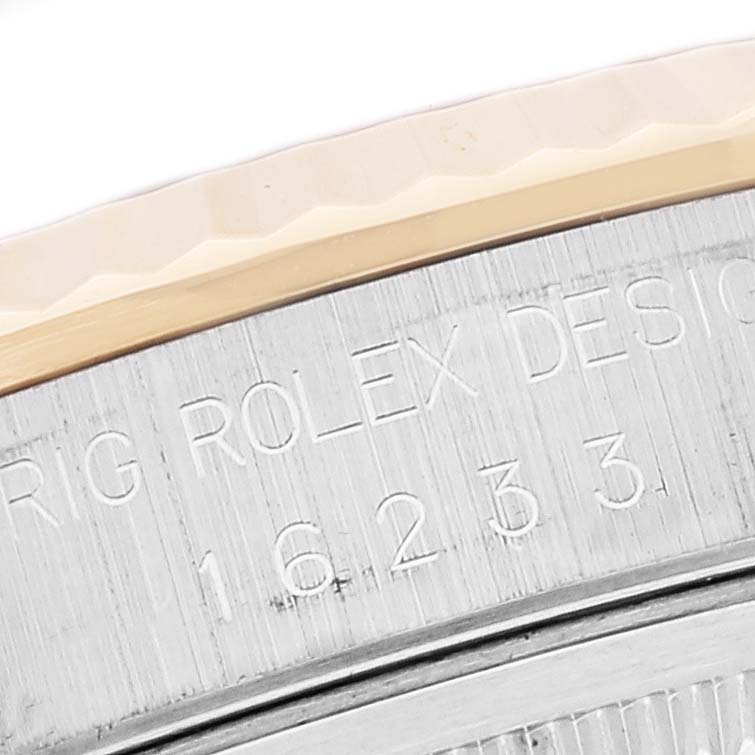This close-up image shows the side of the bezel and the "ROLEX" engraving on a Rolex Datejust 16233 Men's Steel and Gold (two tone) Champagne Dial 16233 Men's Steel and Gold (two tone) Champagne Dial model watch.