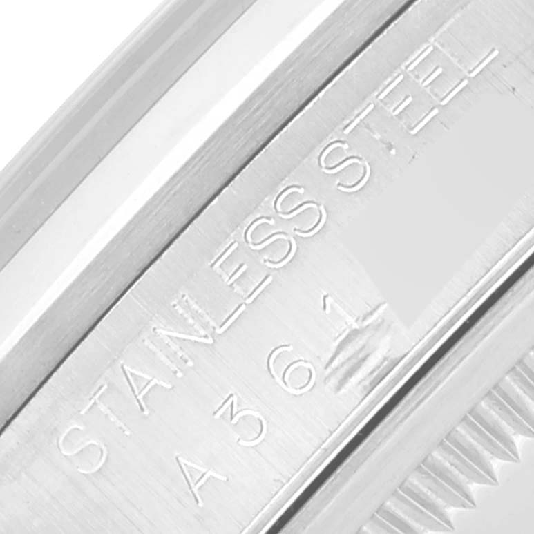 This macro shot showcases the engraved "STAINLESS STEEL" and part of the serial number on the case of a Rolex Datejust 16200 Men's Stainless Steel White Dial 16200 Men's Stainless Steel White Dial.