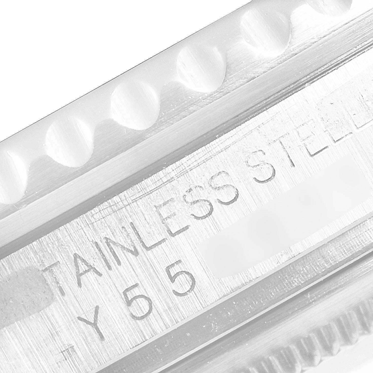 The image shows a close-up view of the edge and engraved details of a Rolex GMT-Master 16710 Men's Stainless Steel Black Dial 16710 Men's Stainless Steel Black Dial watch, focusing on the stainless steel marking.