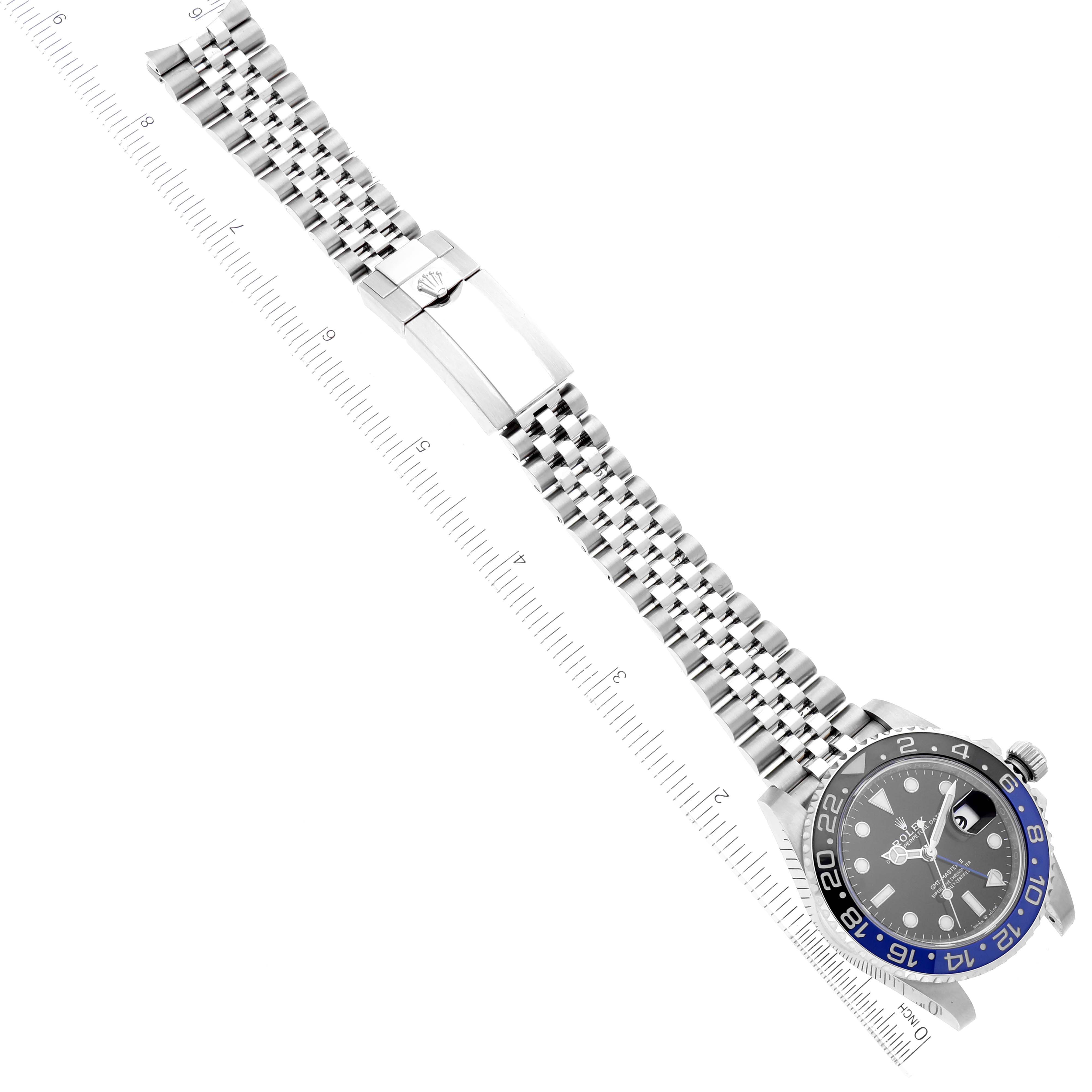 This image shows the Rolex GMT-Master 126710 Men
s Stainless Steel Black Dial 126710 Men
s Stainless Steel Black Dial watch laid flat with its face, bracelet, and clasp visible, alongside a ruler for scale.