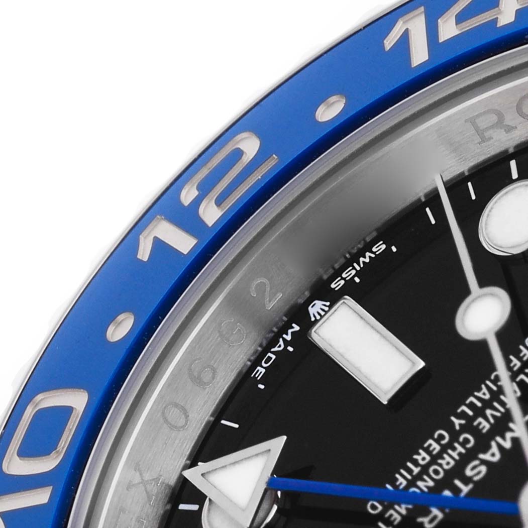 The close-up angle shows the bezel, part of the dial, and hands of the Rolex GMT-Master 126710 Men's Stainless Steel Black Dial, highlighting its blue color and markers.