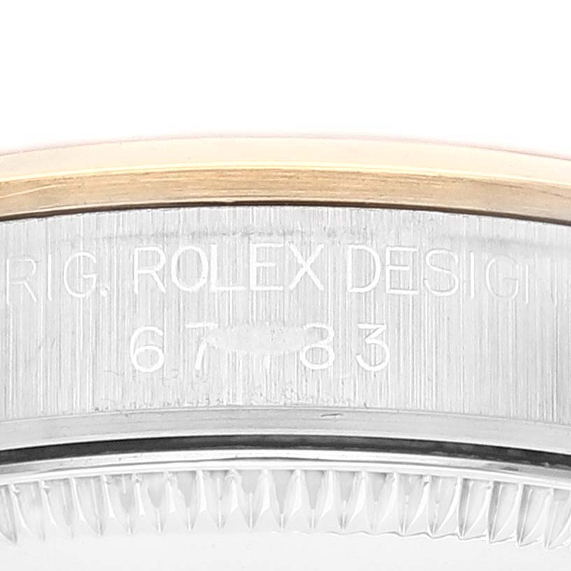 The image shows a close-up of the bezel and engraved serial number on a Mid-Size Rolex watch.