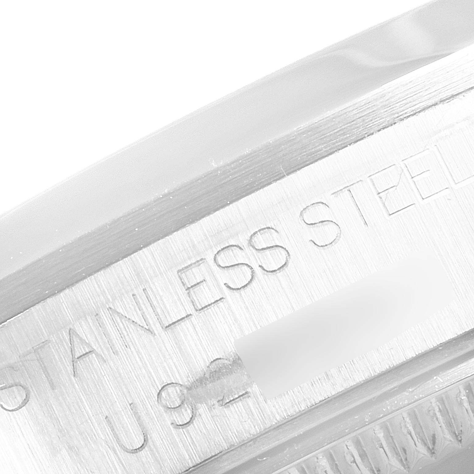 A close-up view of the Rolex Mid-Size 68240 Women
s Stainless Steel Pink Dial 68240 Women
s Stainless Steel Pink Dial model showing part of the stainless steel case and engraving.