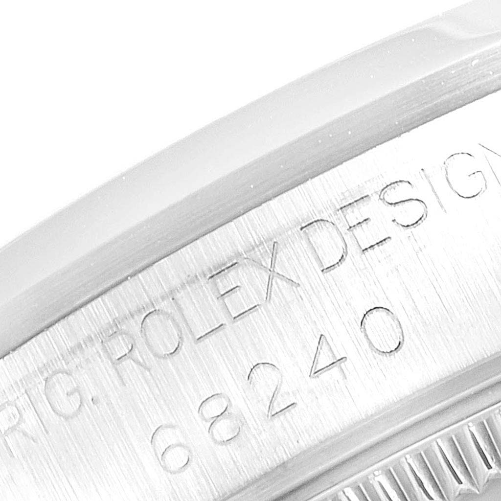 This close-up image shows the engraved model number on the case of a Mid-Size model Rolex watch.
