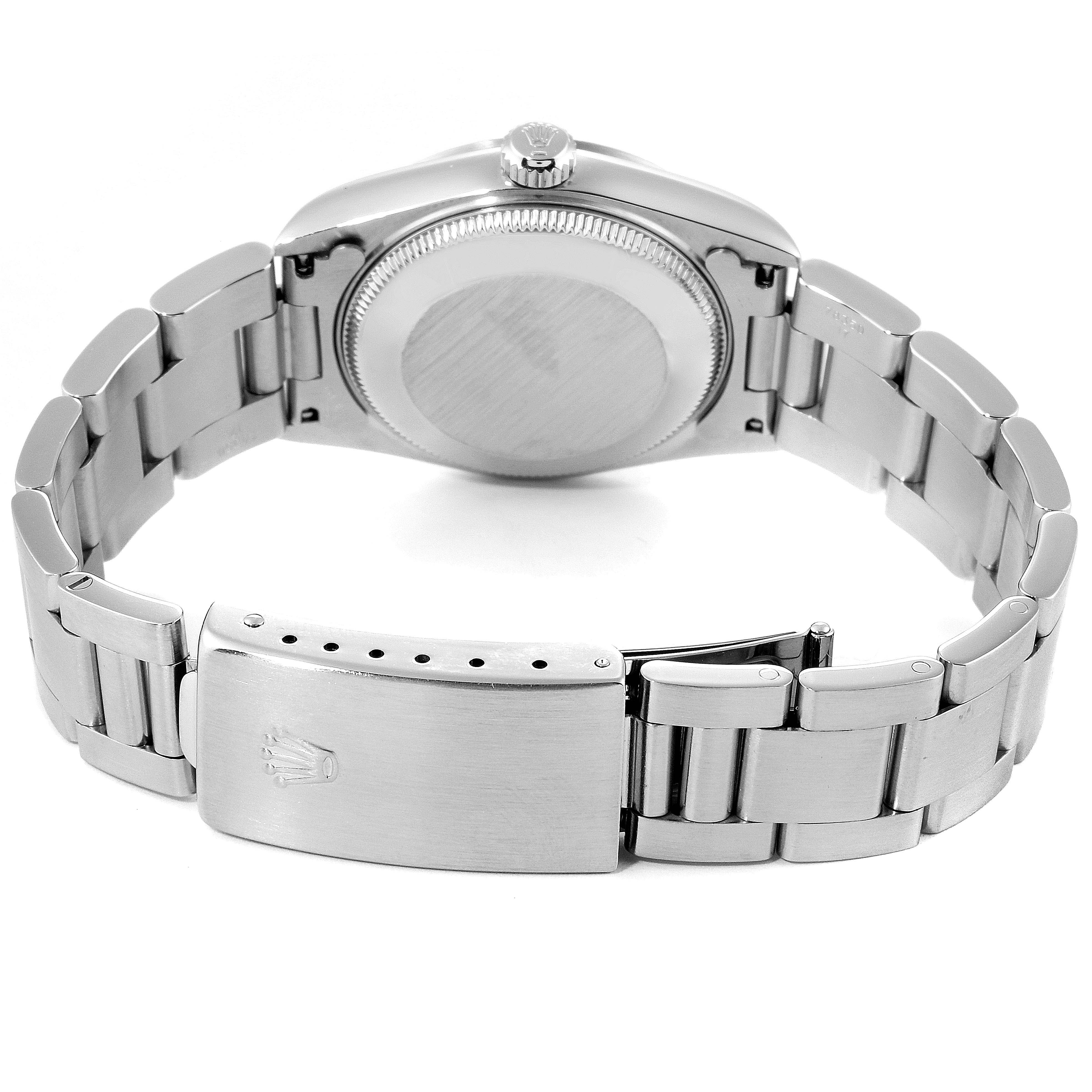 This image shows the back and clasp of a Mid-Size Rolex watch, highlighting the metallic bracelet and closed case.