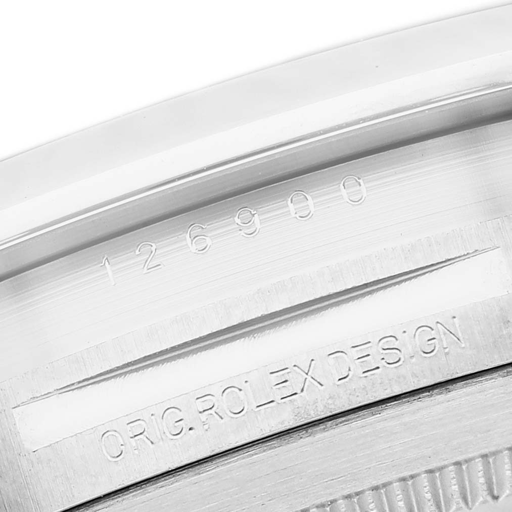 The image shows the side of the Rolex Air-King 126900 Men's Stainless Steel Black Dial, focusing on the engraved model number and "ORIG. ROLEX DESIGN" on the case.