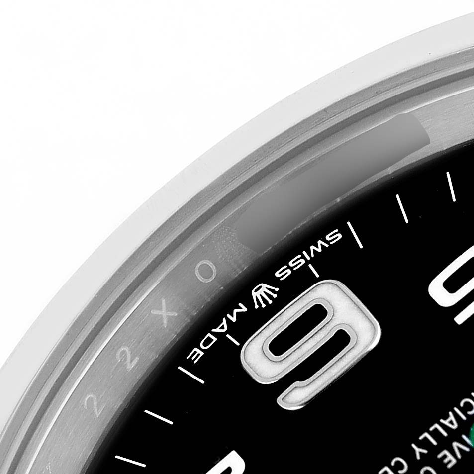 The image shows a close-up of the Rolex Air-King 126900 Men's Stainless Steel Black Dial watch face, focusing on the bezel and part of the dial with numerals.