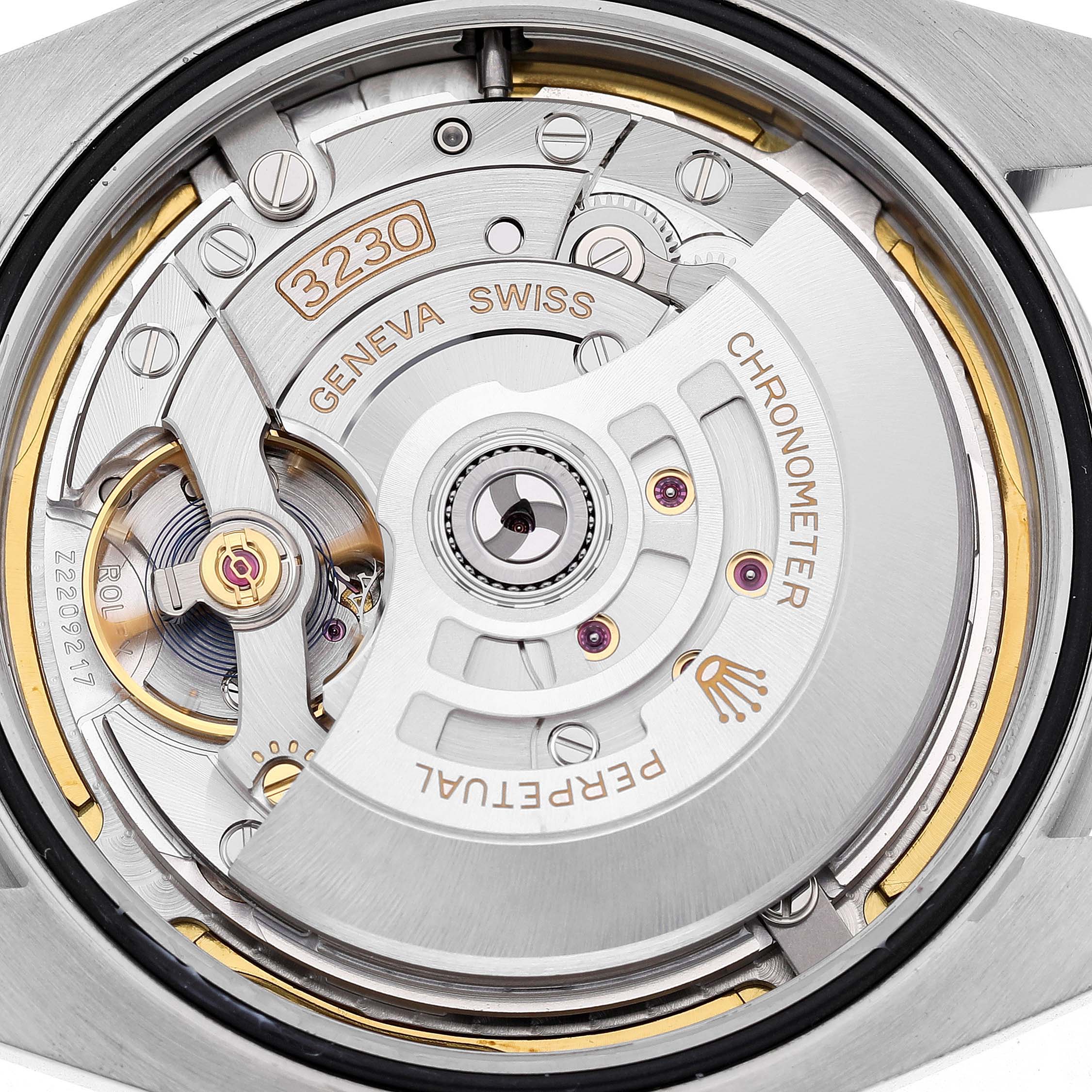 The image shows the movement mechanism of a Rolex Air-King 126900 Men's Stainless Steel Black Dial watch, highlighting the rotor and engraving details.