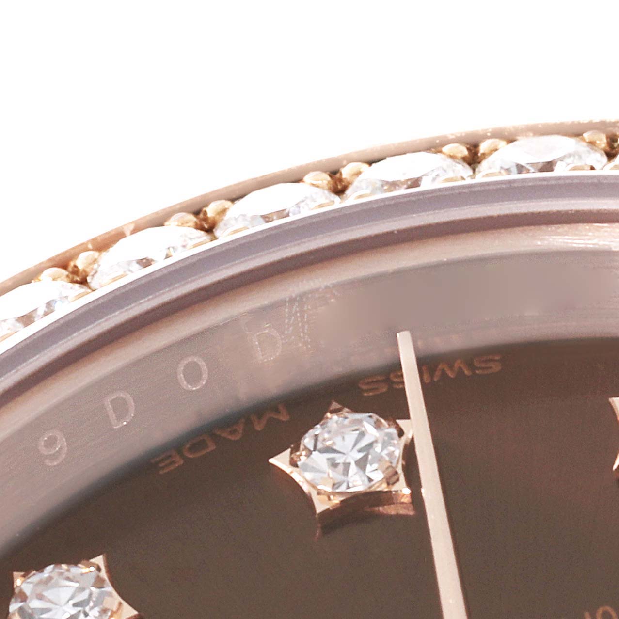 This close-up angle of the Rolex President 279135 Women's Rose Gold Brown Dial 279135 Women's Rose Gold Brown Dial model shows the bezel with diamonds and part of the dial with diamond hour markers.