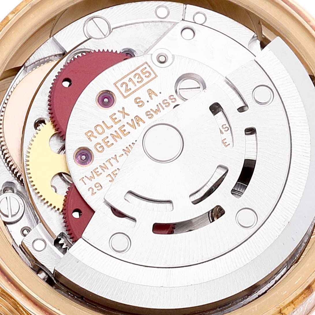 The image shows the intricate internal mechanism of the Rolex President 69178 Women
s Yellow Gold Champagne Dial 69178 Women
s Yellow Gold Champagne Dial model watch, including its gears and movement parts.