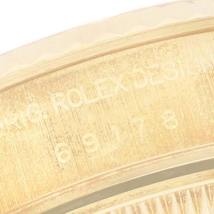 The image shows a close-up view of the side engraving on a Rolex President 69178 Women
s Yellow Gold Champagne Dial 69178 Women
s Yellow Gold Champagne Dial model watch, highlighting the model number.