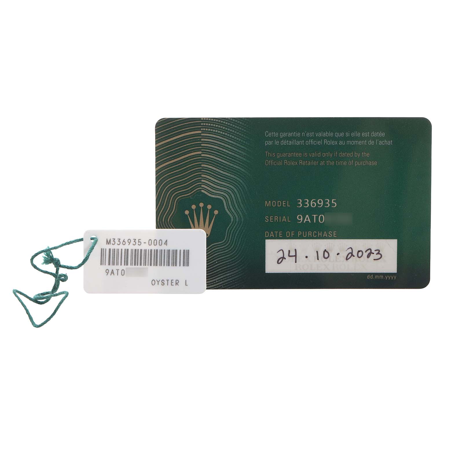 This image shows a Rolex Sky-Dweller 326935 Men's Rose Gold Grey Dial model warranty card and a tag with serial and model numbers.