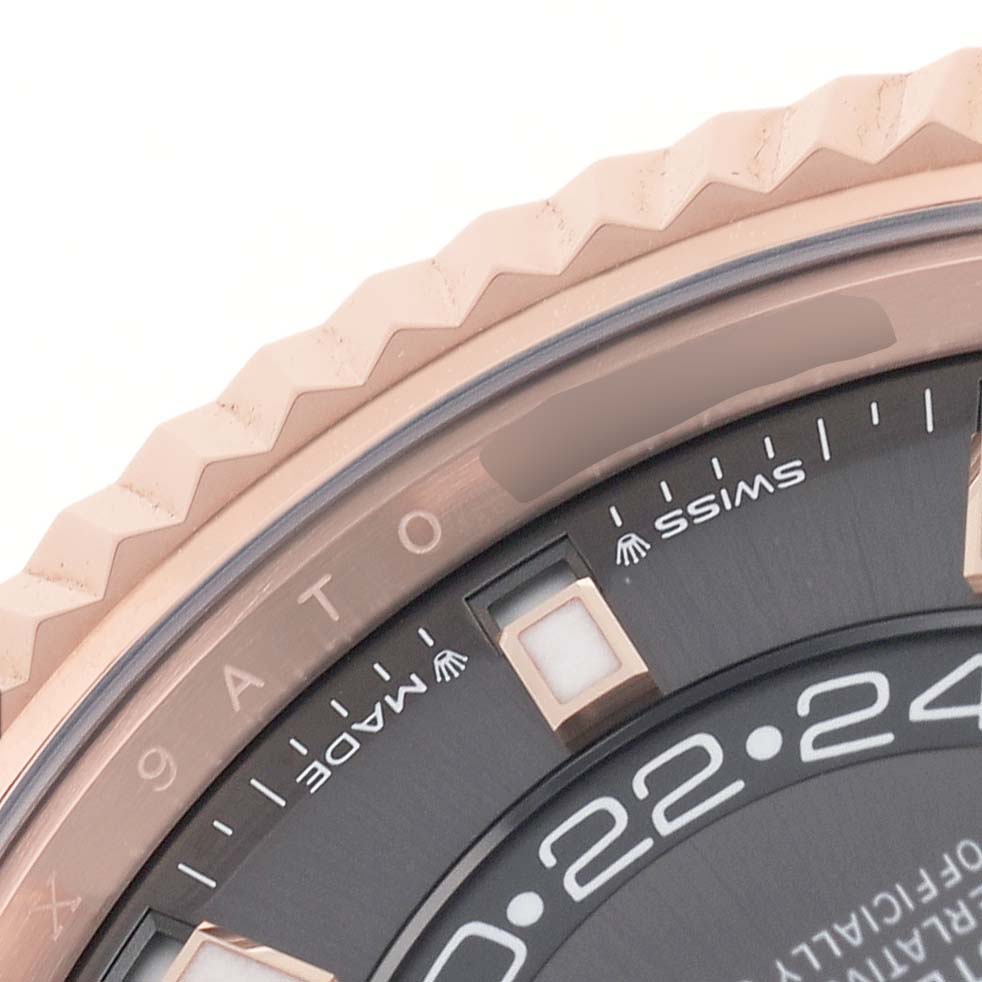 The image shows a close-up of the bezel and part of the dial of a Rolex Sky-Dweller 326935 Men's Rose Gold Grey Dial watch, highlighting the text and markers.