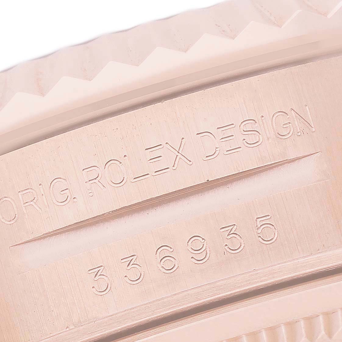 The image shows a close-up of the engraved side of a Rolex Sky-Dweller 326935 Men's Rose Gold Grey Dial watch, highlighting the model details and design markings.